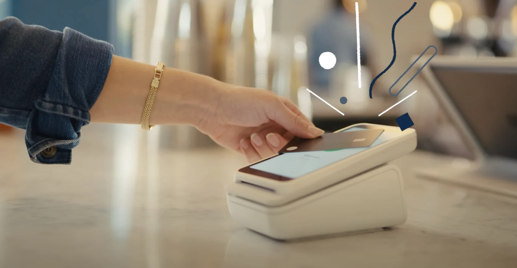 Customer tapping a card on a Stripe Terminal reader at a repair shop counter